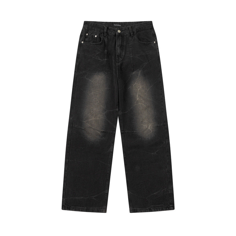 Black distressed jeans on a white background