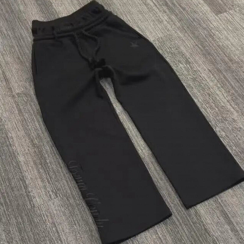 Black pants on a gray textured floor