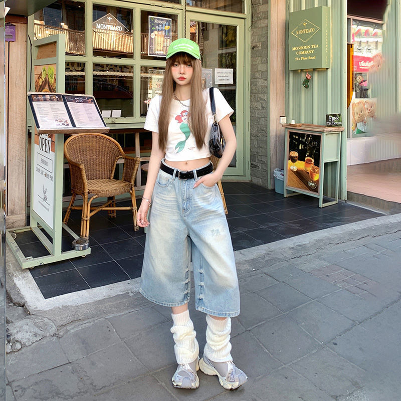 Woman in casual outfit standing outside a McDonald's restaurant